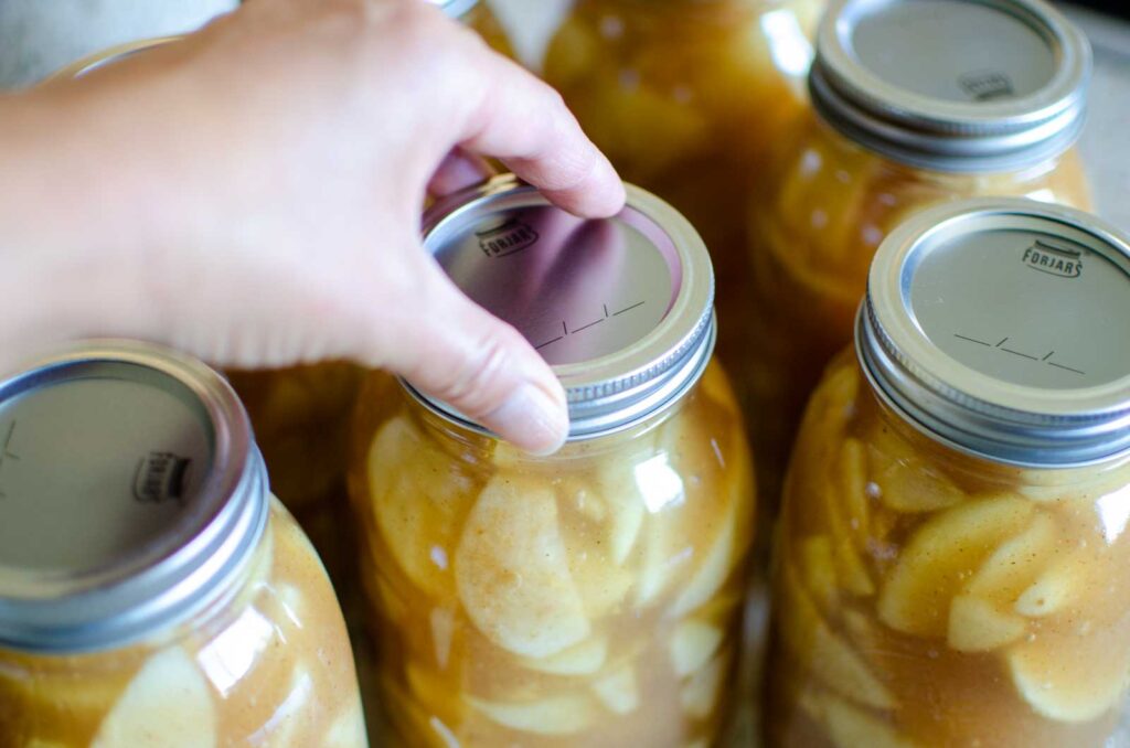 placing two piece lid on canning jar