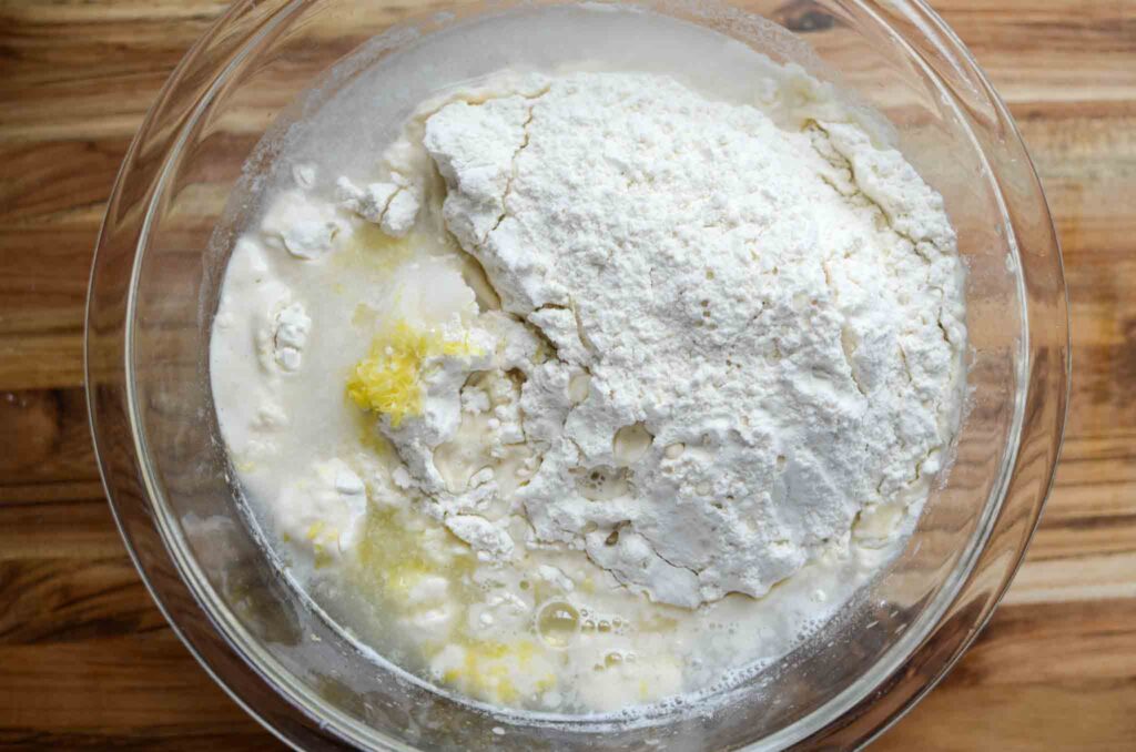 a glass bowl with sourdough lemon focaccia bread