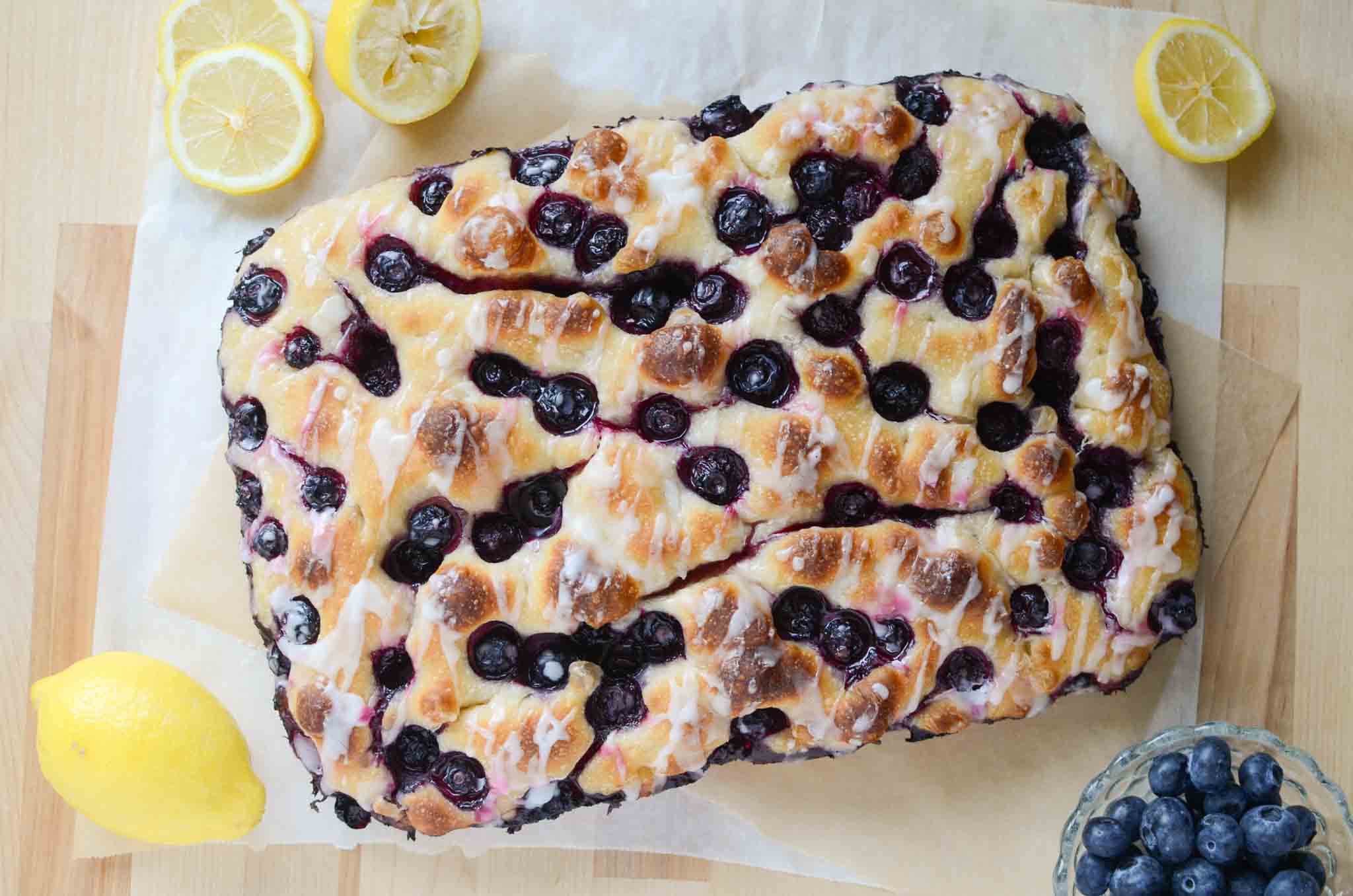 sourdough lemon blueberry focaccia bread with cut lemons