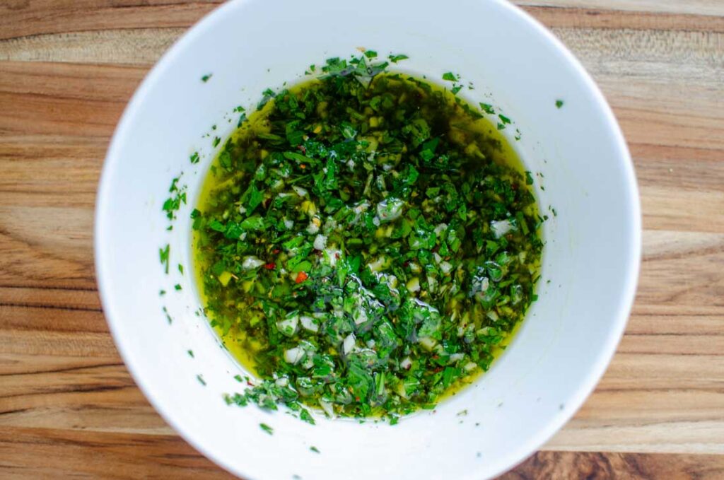 chimichurri sauce in a white bowl