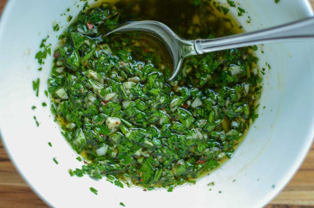 chimichurri sauce in a white bowl