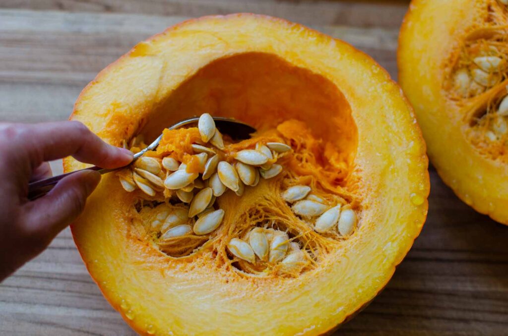 Scooping out the seeds from a pumpkin 