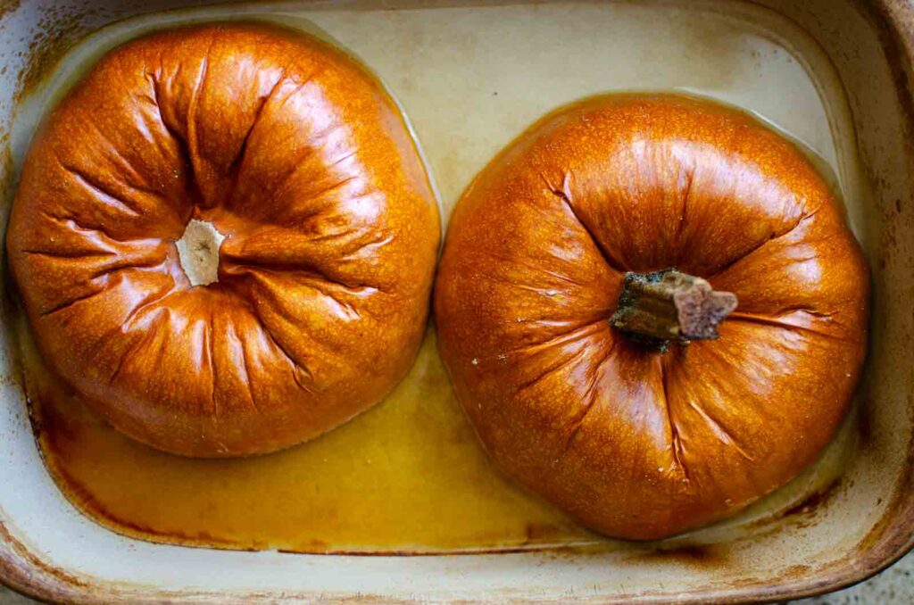 baked pumpkin halves in baking dish