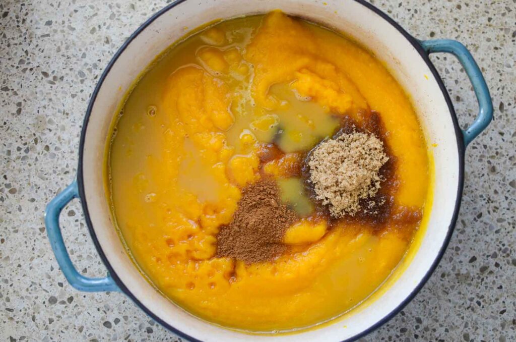 Ingredients in Dutch oven for maple bourbon pumpkin butter