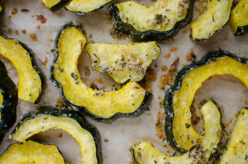 herb roasted parmesan acorn squash pieces on pan