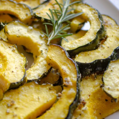 sliced herb roasted parmesan acorn squash on platter