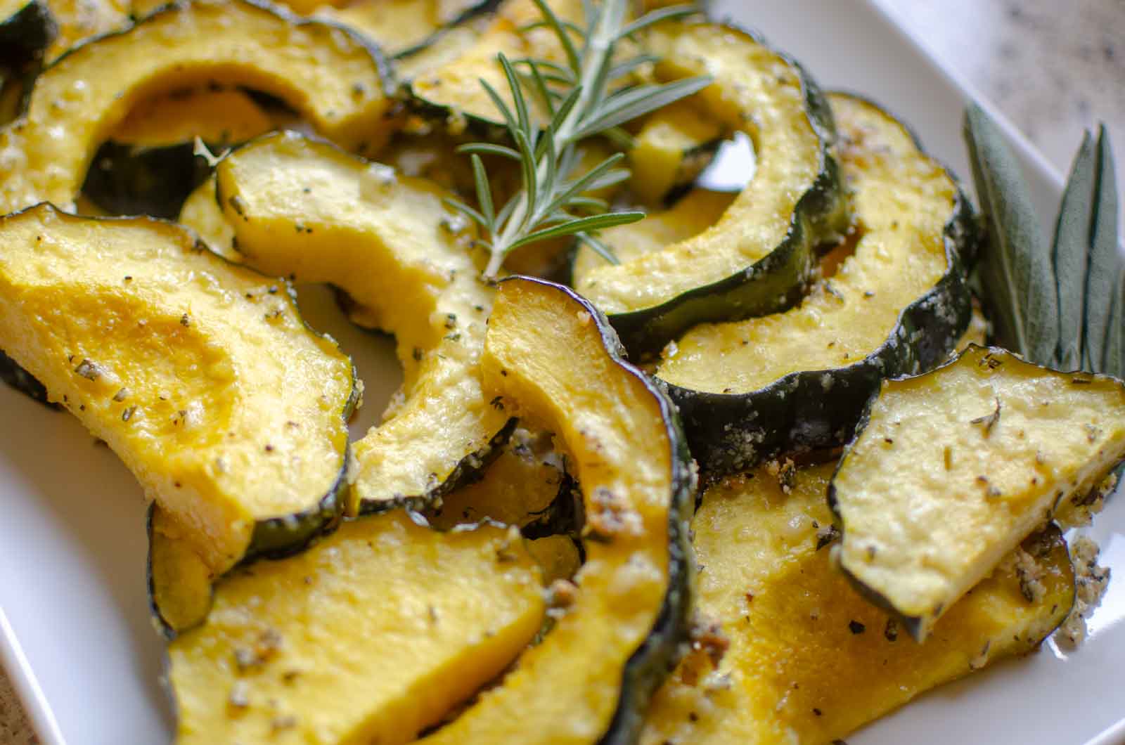 sliced herb roasted parmesan acorn squash on platter