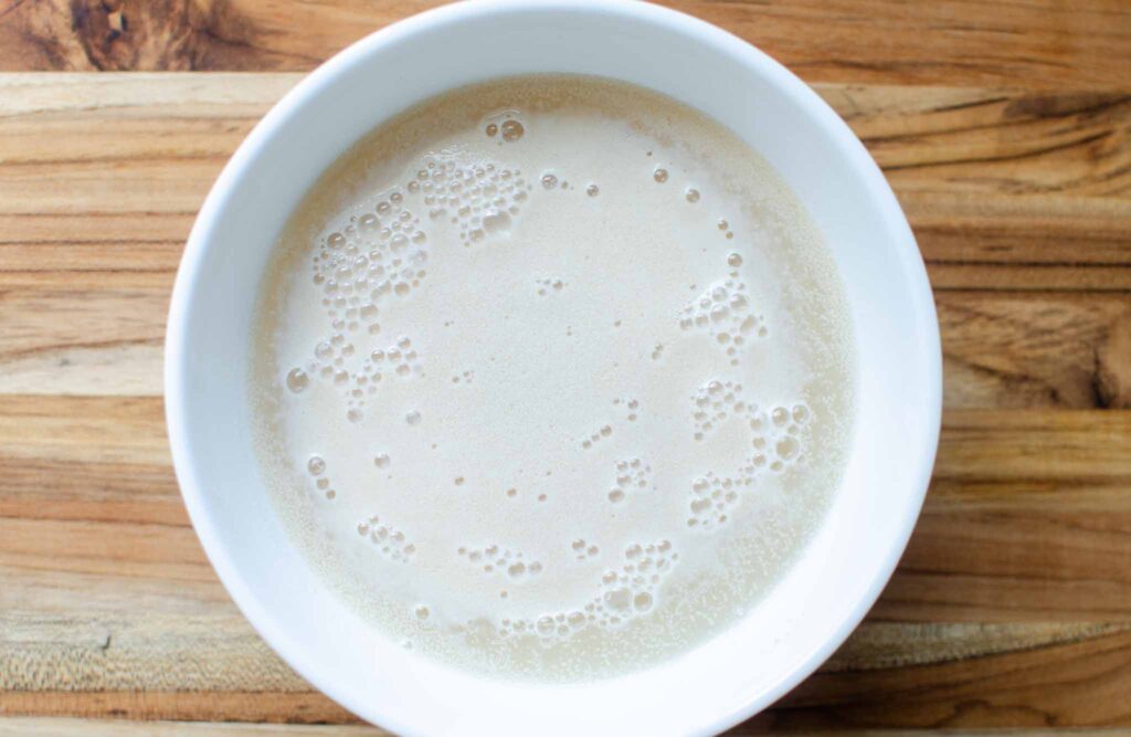 yeast and water in a white bowl