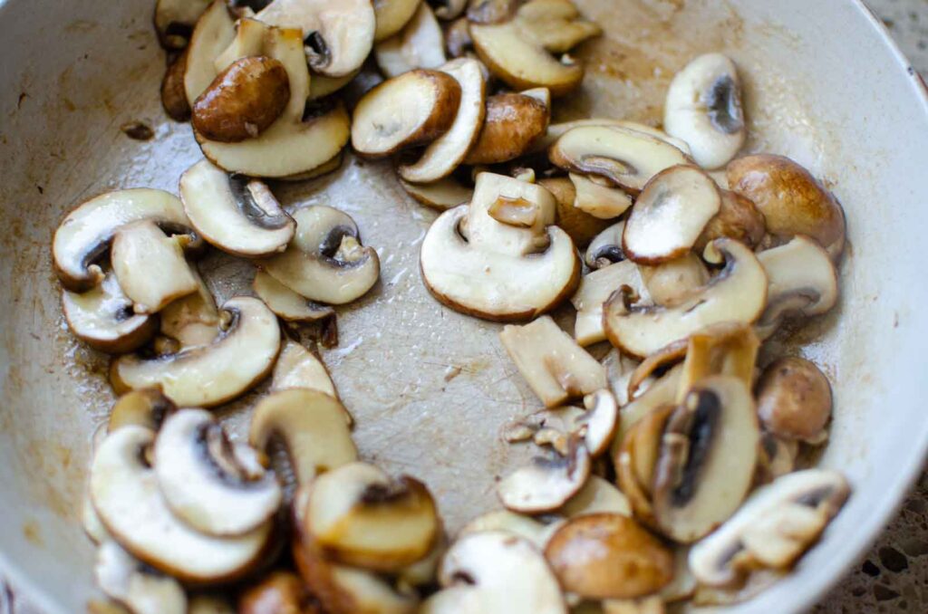 sauteed sliced mushrooms in frying pan