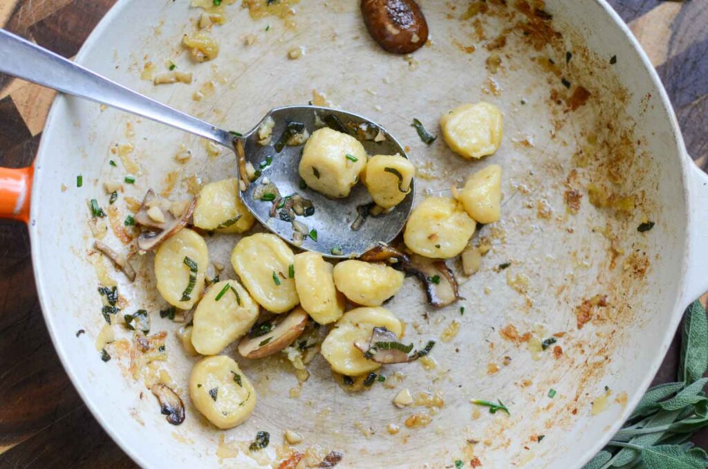 a half-full pan of ricotta gnocchi with mushrooms 