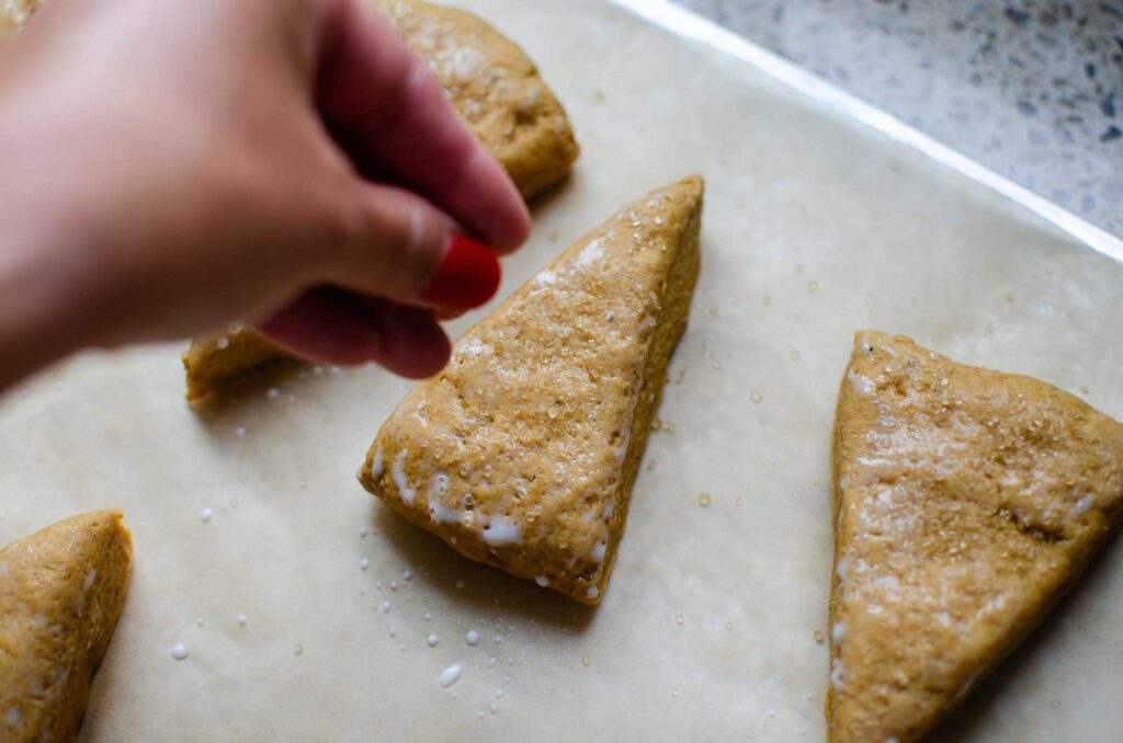 sprinkling sugar over scones