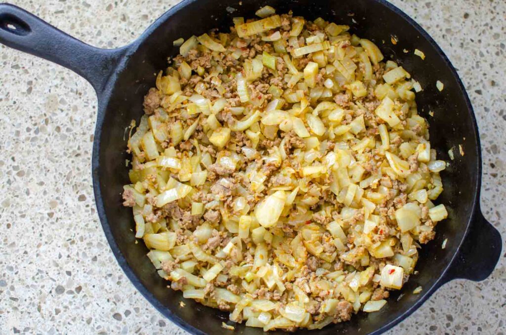 sauteed fennel, onion and Italian sausage in cast iron skillet