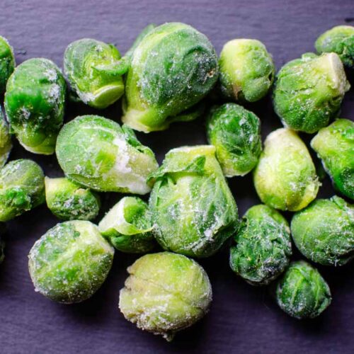 Frozen brussels sprouts on a piece of slate