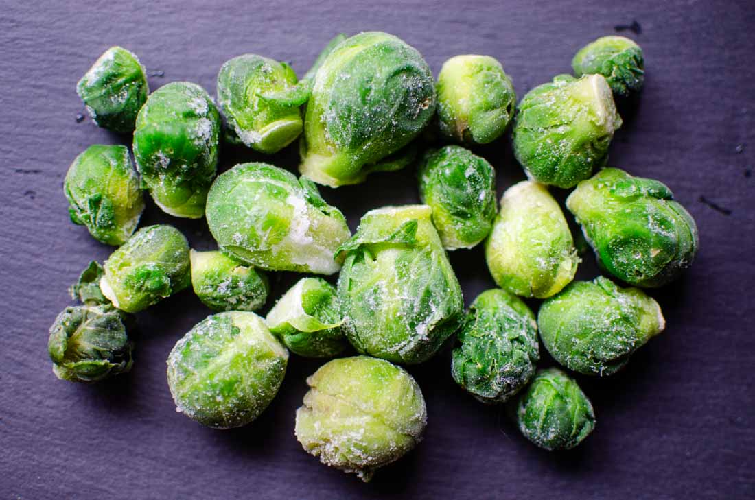 Frozen brussels sprouts on a piece of slate