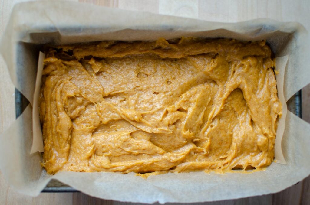 sourdough pumpkin quick bread batter in loaf pan