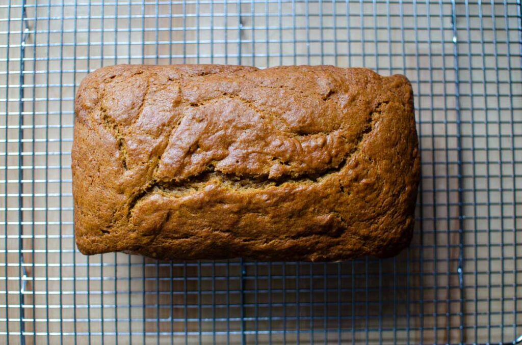 sourdough pumpkin quick bread loaf on wire rack