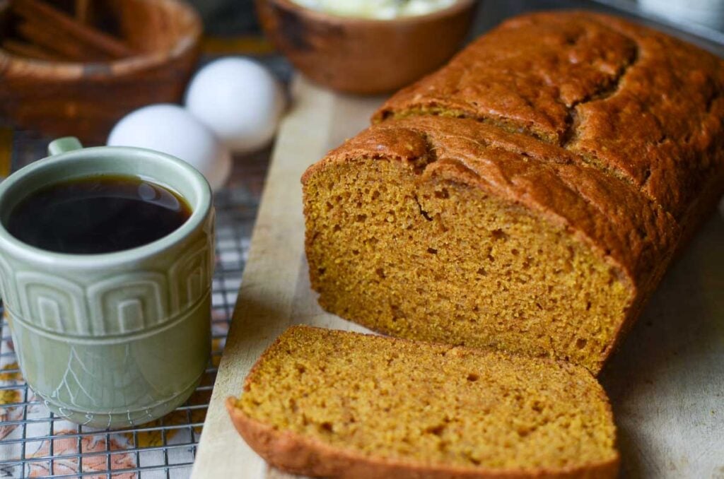 Same Day Sourdough Discard Pumpkin Quick Bread slices on a wooden cutting board