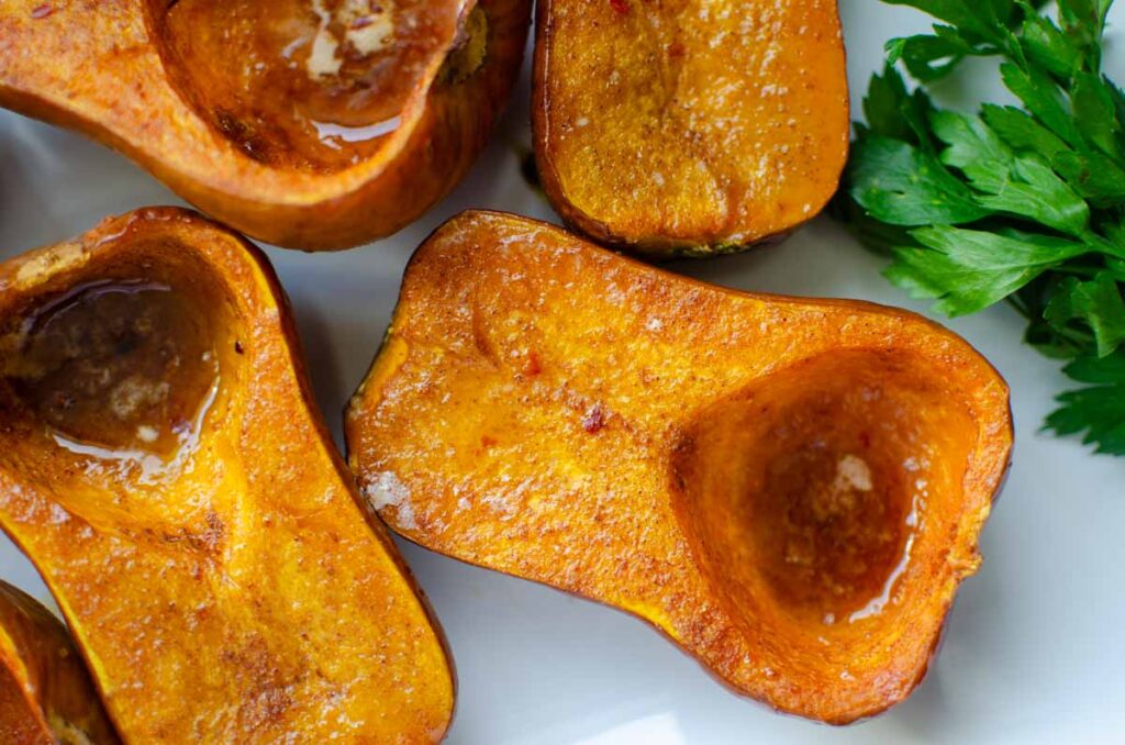 curry flavored honeynut squash halves on serving tray