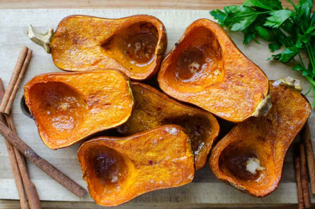 roasted curry flavored honeynut squash halves on serving board