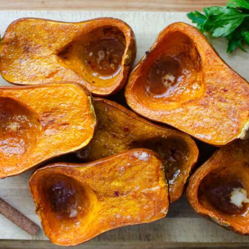 roasted curry flavored honeynut squash halves on serving board