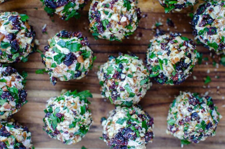 mini cranberry pecan goat cheese truffle balls on a wooden board