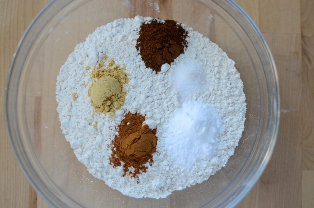 the dry ingredients for sourdough molasses cookies in a glass bowl