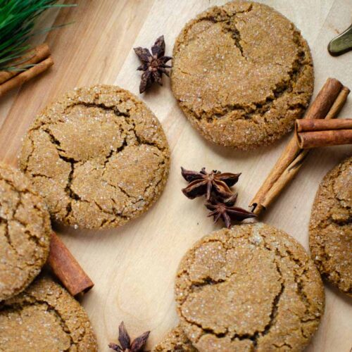 soft and chewy sourdough discard molasses cookies on a wood surface