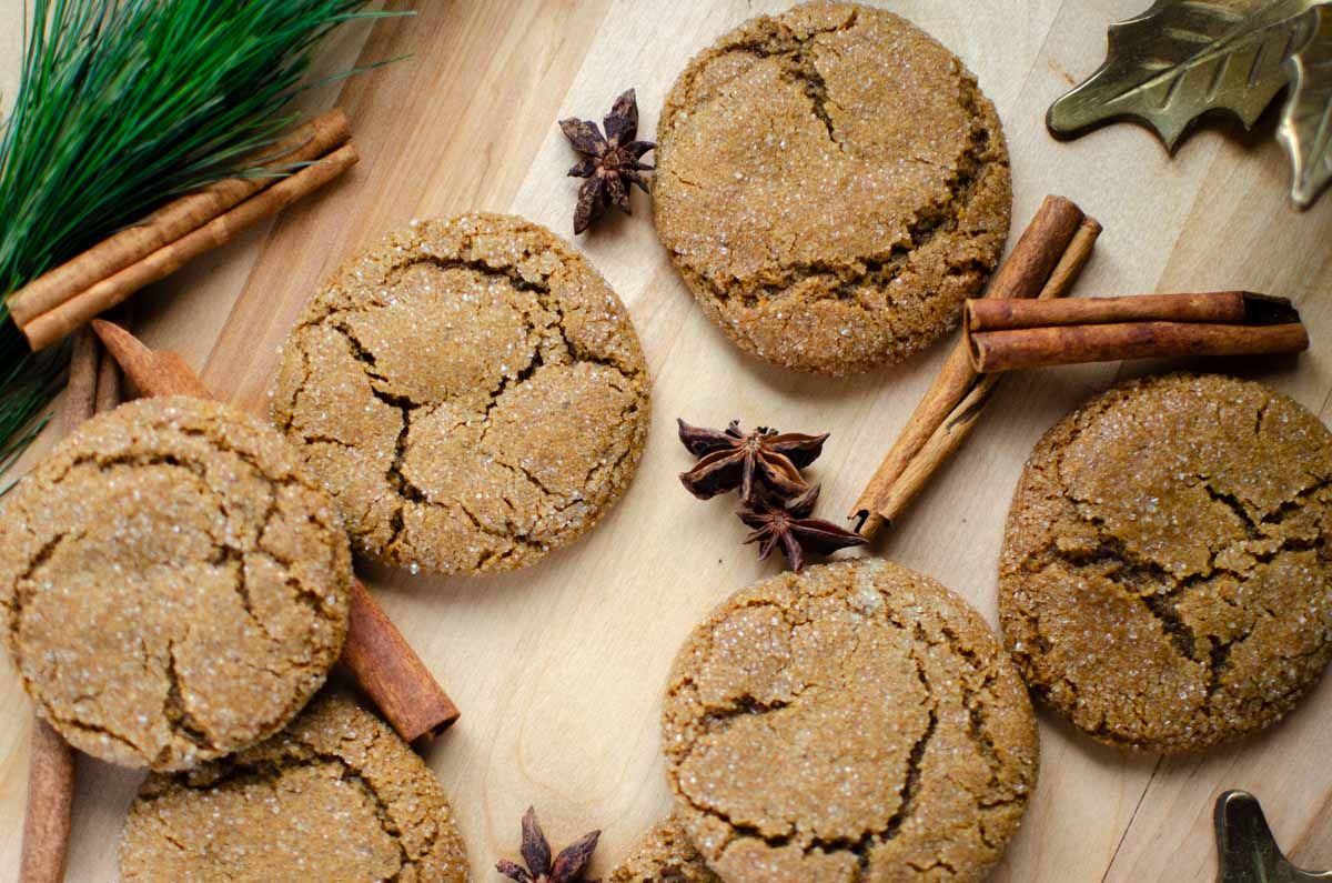 soft and chewy sourdough discard molasses cookies on a wood surface