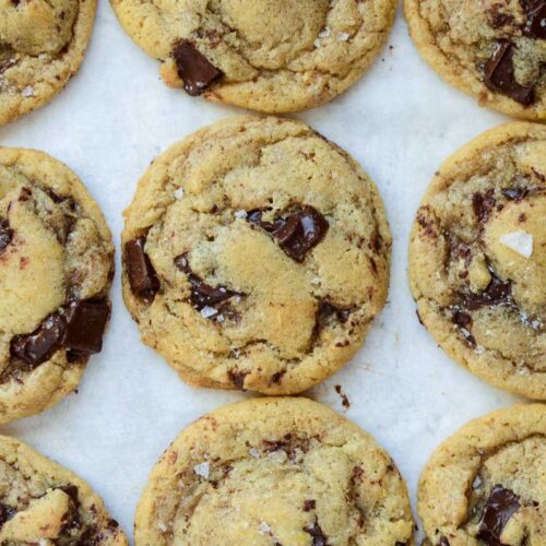 brown butter sourdough discard chocolate chip cookies on a white piece of parchment paper