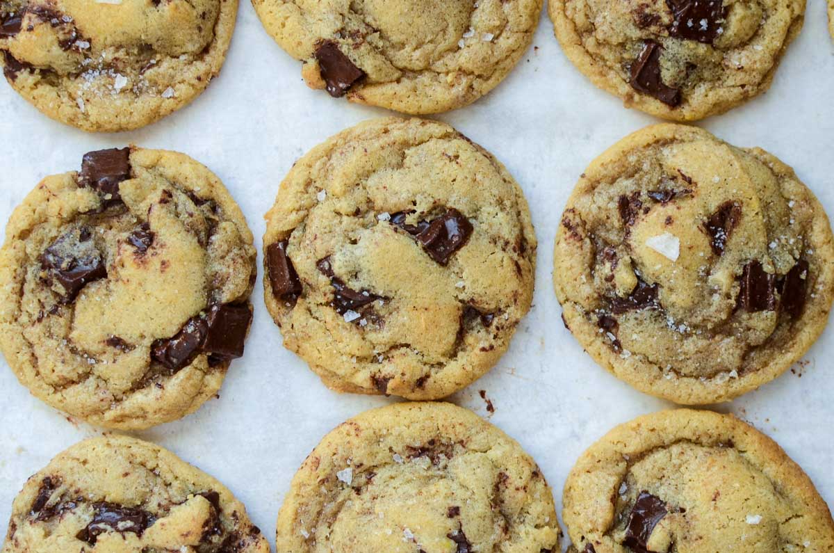 brown butter sourdough discard chocolate chip cookies on a white piece of parchment paper