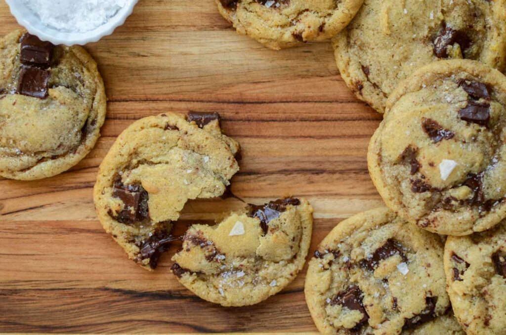 sourdough chocolate chip cookies on a wood surface