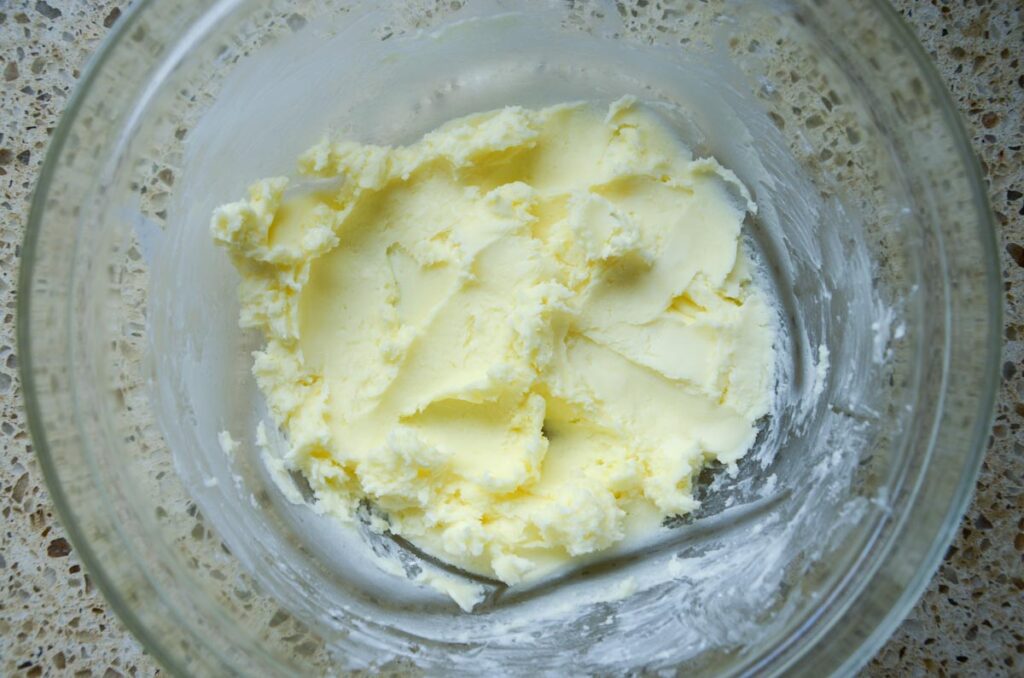 creaming butter and powdered sugar in large glass bowl