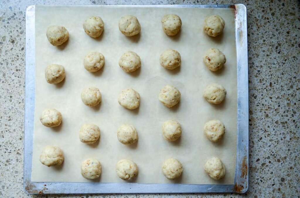 unbaked sourdough cookie dough balls on baking sheet