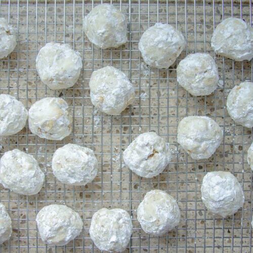 many sourdough Russian tea cake cookies on a wire rack