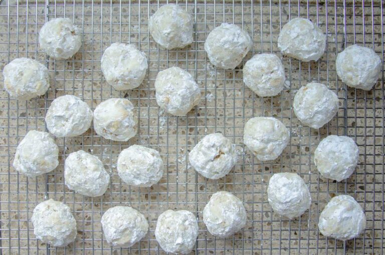 many sourdough Russian tea cake cookies on a wire rack