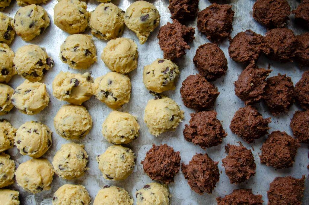 scooped cookie dough on a baking sheet