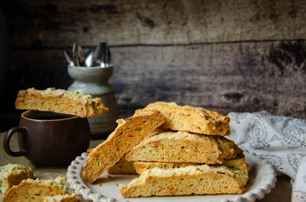 biscotti on a plate and on a cup of coffee