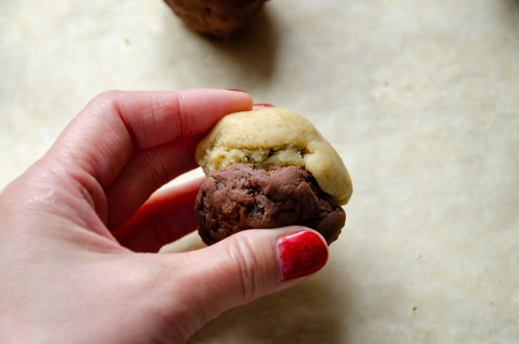 holding a brookie dough ball in a hand