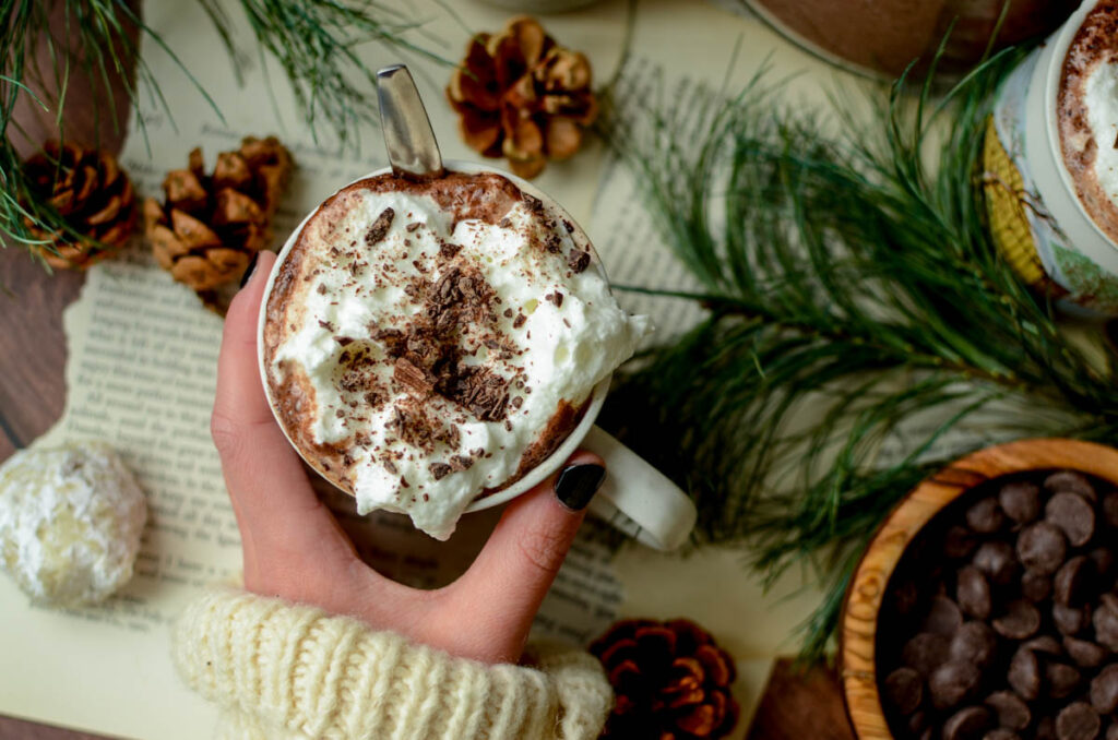 hand holding a cup a hot cocoa