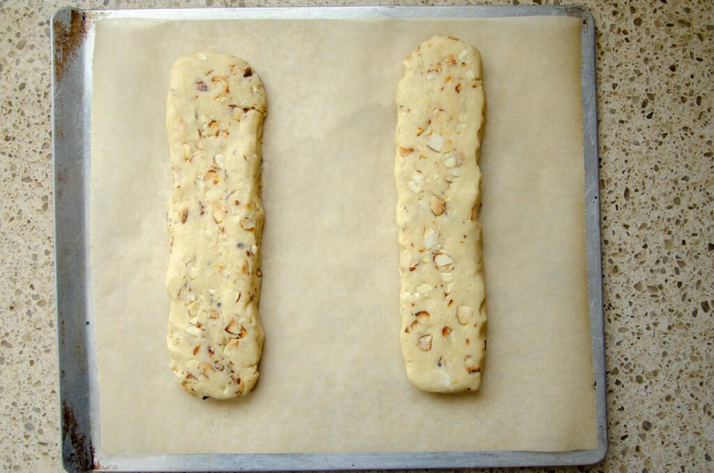 shaped unbaked sourdough biscotti dough on baking sheet