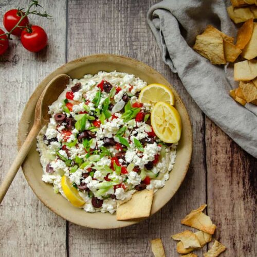 Mediterranean hummus dip in stone dish with pita chips