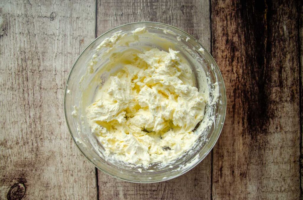 butter and cream cheese blended in a glass bowl 