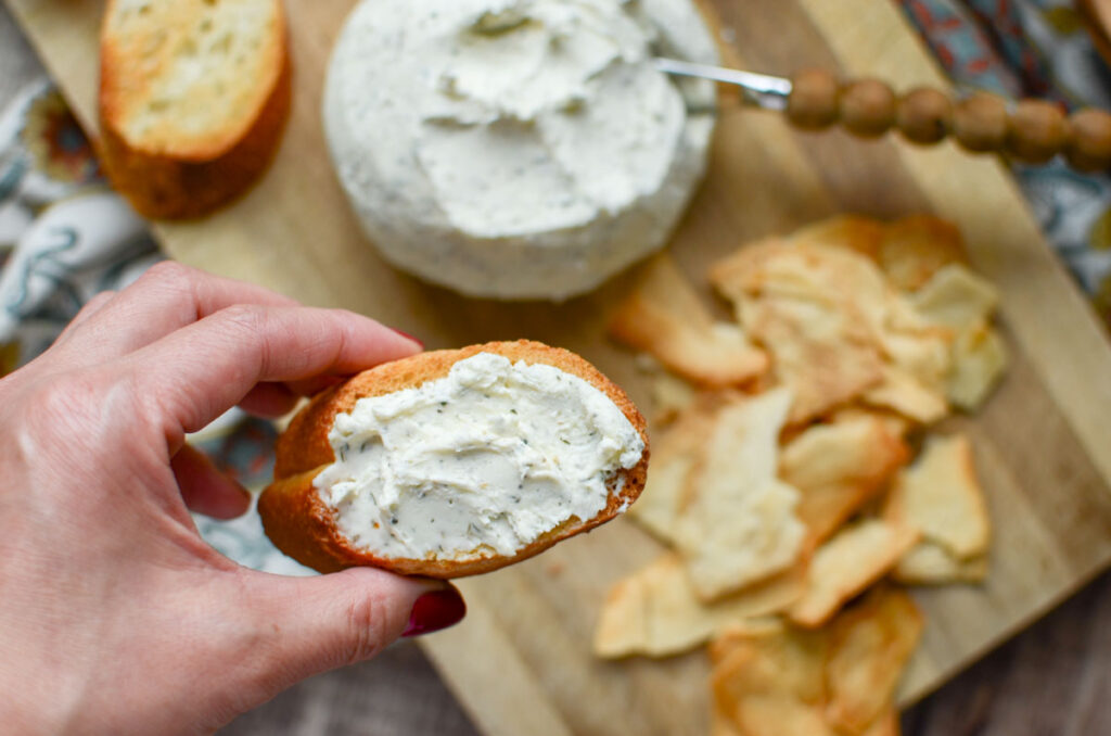 Boursin cheese spread on a baguette slice