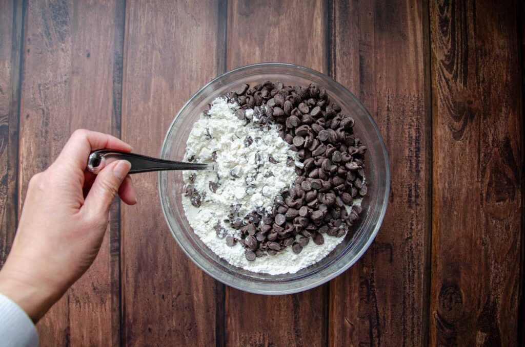 dry ingredients with chocolate chips in a glass bowl