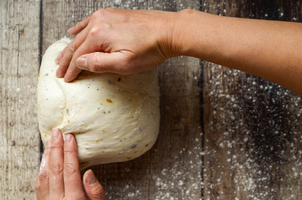 folding the opposite side of the dough over