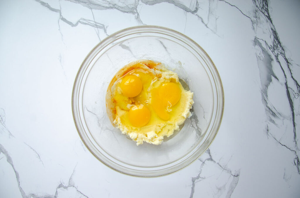 adding wet ingredients to the creamed butter and sugar