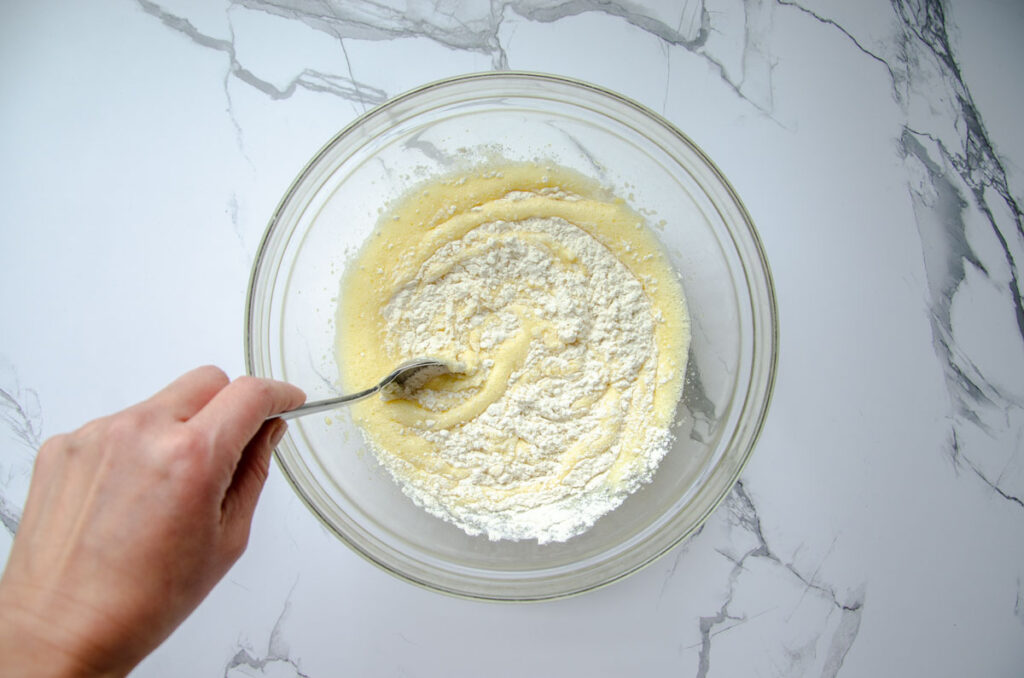 stirring flour into the wet ingredients in a glass bowl