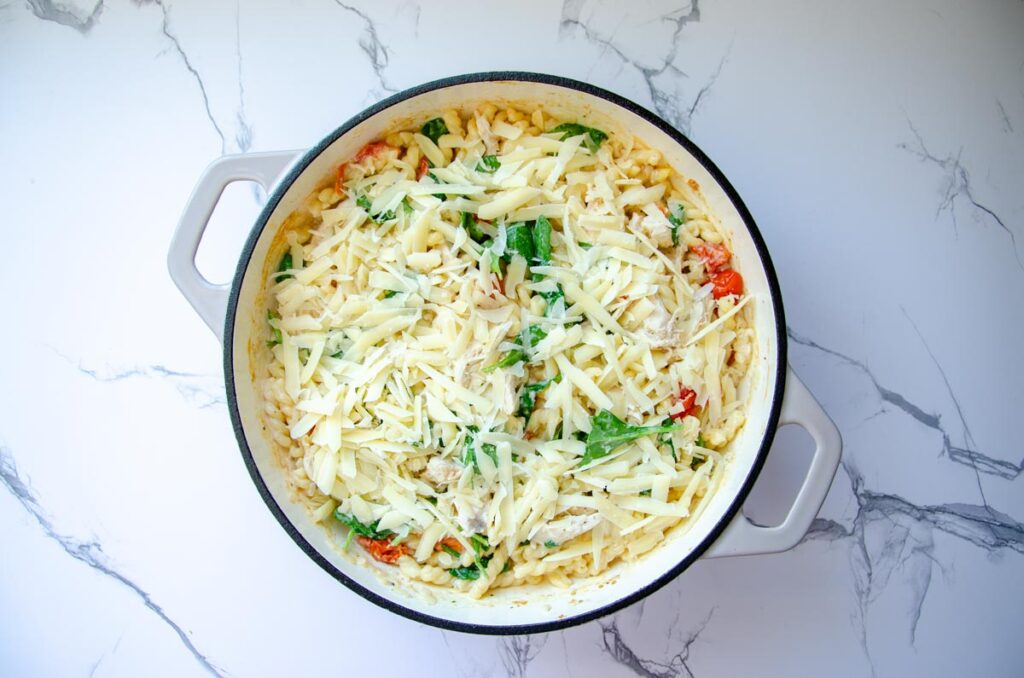 Boursin chicken pasta bake with spinach and grated parmesan