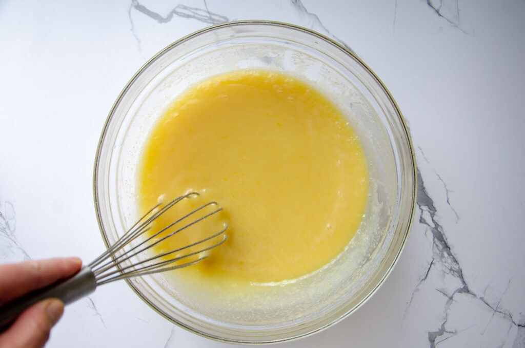 mixed wet ingredients for chocolate espresso cake in a glass bowl