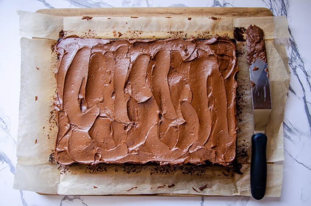 frosted chocolate espresso cake with an offset spatula 